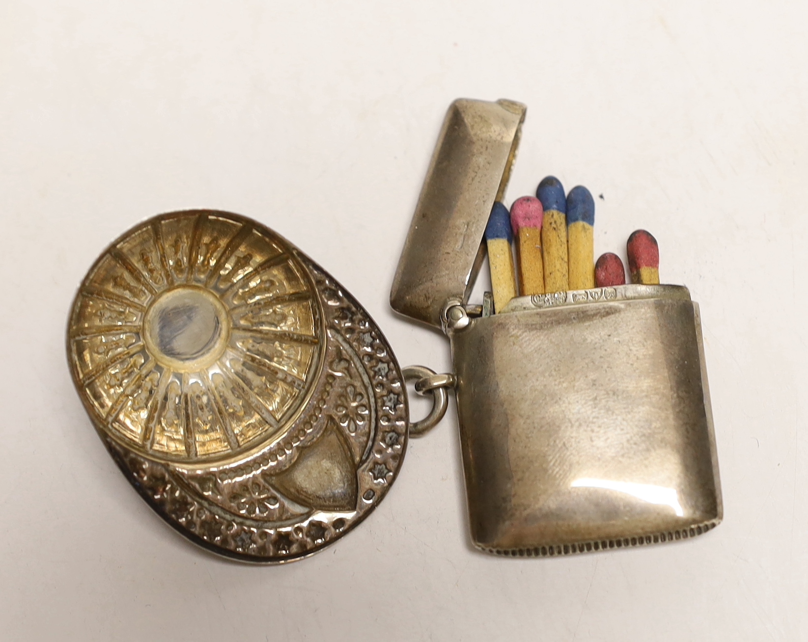 An Elizabeth II silver jockey cap caddy spoon, Francis Howard Ltd, Sheffield, 1973, 52mm and and an Edwardian silver vesta case.